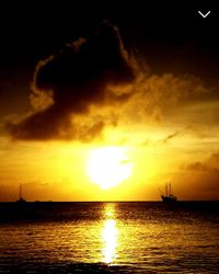 Scenic view of sea against dramatic sky during sunset