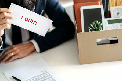 Midsection of man holding text on paper