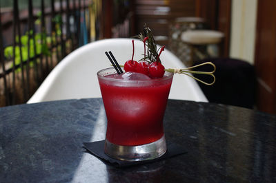 Close-up of red wine with drink on table