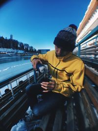 Man sitting against clear sky