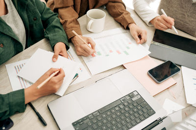 Midsection of business colleagues working at office