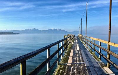 Pier over lake against sky