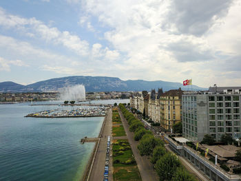 View of cityscape against cloudy sky