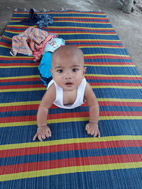 Portrait of cute baby boy on floor