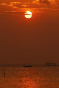 Scenic view of sea against orange sky