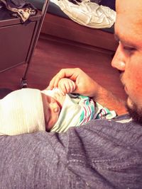 Portrait of smiling boy lying on bed