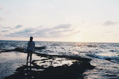 Man on beach against sky