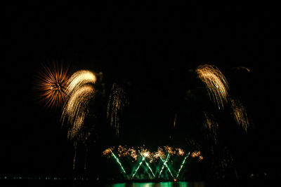 Low angle view of firework display at night