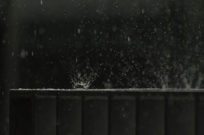 Close-up of raindrops on water