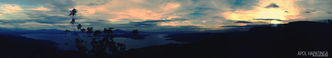 SCENIC VIEW OF MOUNTAINS AGAINST CLOUDY SKY AT SUNSET