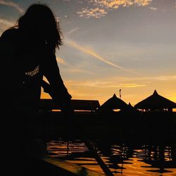 Silhouette of woman at sunset