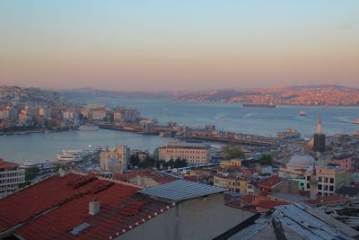 High angle view of town by sea against sky