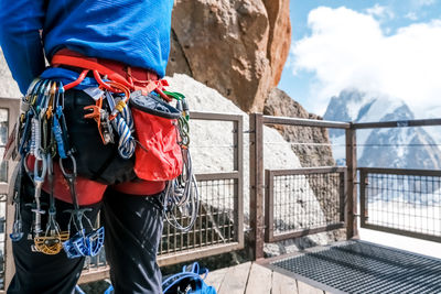 Low section of man standing against mountain