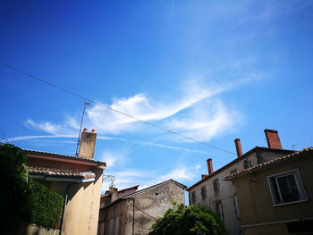 Low angle view of buildings against blue sky