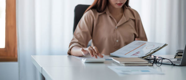 Midsection of businesswoman at office