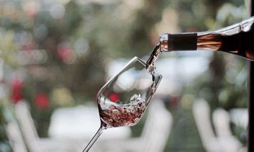 Close-up of wine being poured in glass