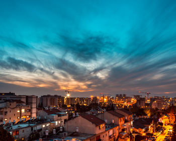 High angle view of illuminated buildings against sky at sunset