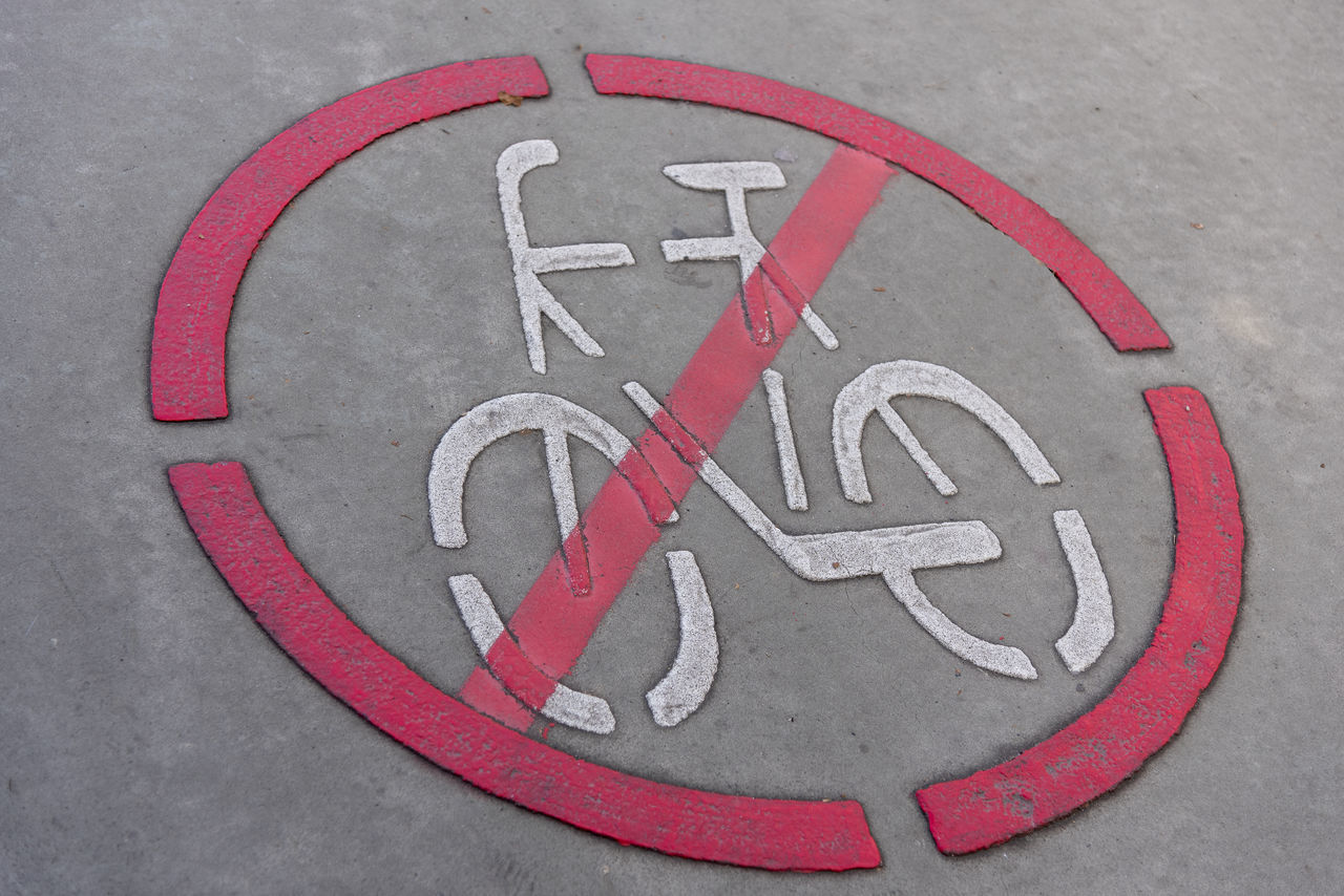 sign, font, communication, circle, number, road, bicycle, transportation, symbol, geometric shape, no people, red, shape, street, city, road sign, forbidden, gray, warning sign, close-up, wheel, high angle view, guidance, information sign, signage