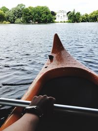 Close-up of hand on boat sailing in river