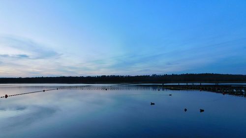 Scenic view of calm lake against sky