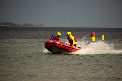 People surfing in sea