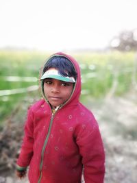 Portrait of girl standing on field