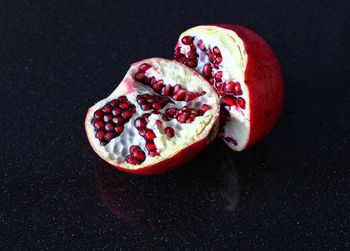 Close-up of pomegranate against black background