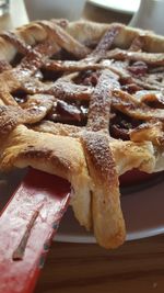 Close-up of apple pie in plate on table