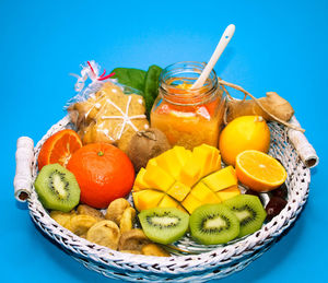 Close-up of fruits in wicker basket on table