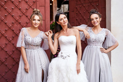 Portrait of bride standing against wall