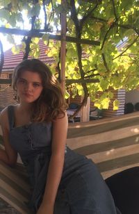 Portrait of a young woman sitting outdoors