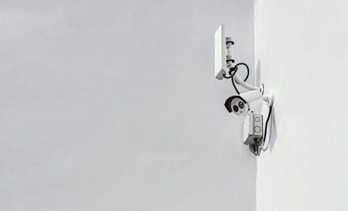 Low angle view of electric lamp hanging on wall