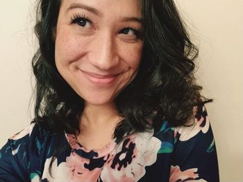 Close-up portrait of a smiling young woman