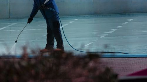 Low section of man working in water