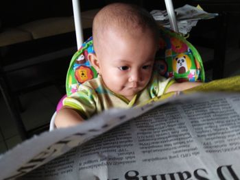 Portrait of cute boy reading book