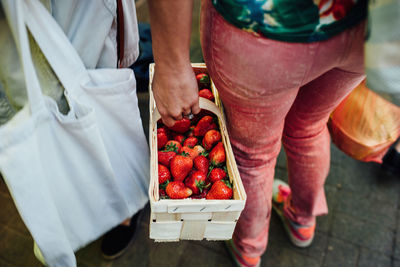 Low section of man standing on display at market