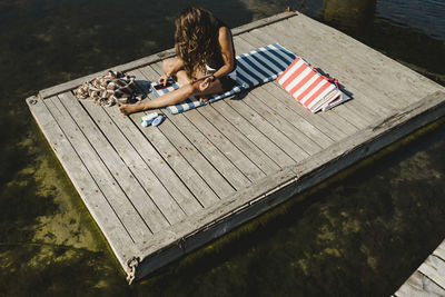 Woman sitting on jetty