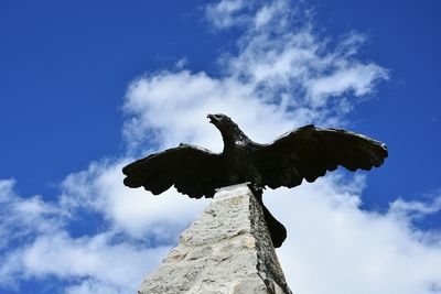 Low angle view of statue of bird against sky