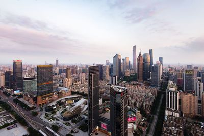 View of cityscape against cloudy sky