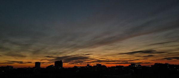 Silhouette trees against sky at sunset