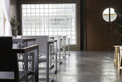 Empty chairs and table against window at home