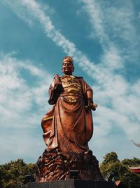 Low angle view of statue against sky