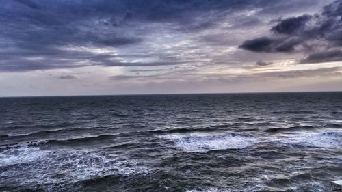 Scenic view of sea against cloudy sky