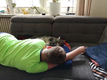 Boy relaxing on sofa at home