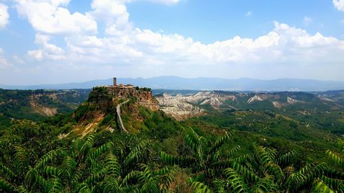 Trees growing at civita di borgoregio against cloudy sky