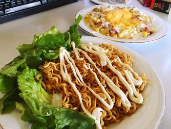 High angle view of serving noodles in plate on table