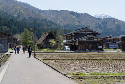 People on mountain against sky