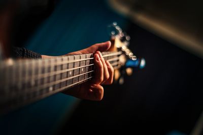 Close-up of hand playing guitar