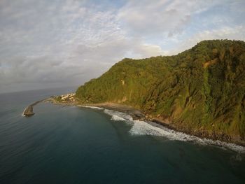 View of beach against cloudy sky