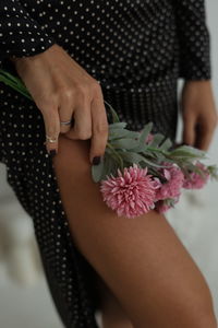 Midsection of woman holding bouquet